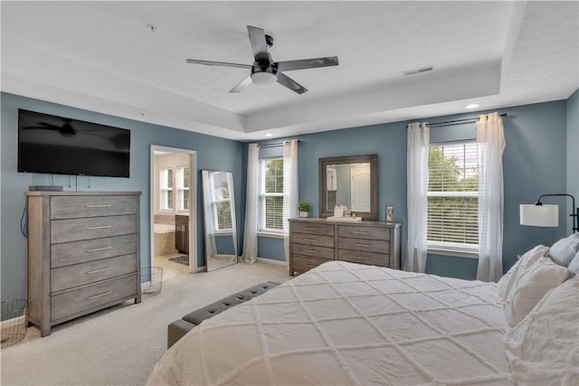 2278 Flint Dr, South Strabane, PA 15301 - bedroom with light colored carpet, multiple windows, a tray ceiling, ensuite bath, and recessed lighting