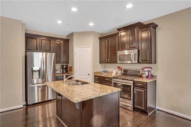 2278 Flint Dr, South Strabane, PA 15301 - kitchen with appliances with stainless steel finishes, dark brown cabinets, light stone counters, a center island with sink, and recessed lighting