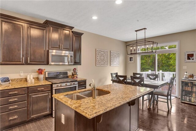 2278 Flint Dr, South Strabane, PA 15301 - kitchen featuring stainless steel appliances, light stone countertops, dark brown cabinetry, recessed lighting, and wine cooler