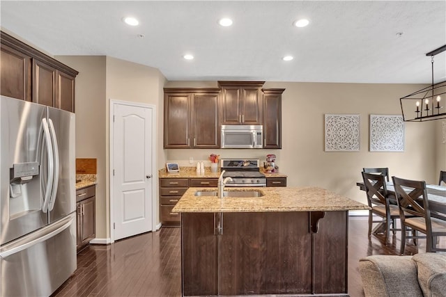 2278 Flint Dr, South Strabane, PA 15301 - kitchen featuring appliances with stainless steel finishes, light stone counters, a chandelier, dark brown cabinets, and recessed lighting