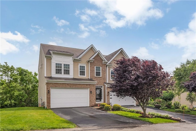 2278 Flint Dr, South Strabane, PA 15301 - view of front of home with brick siding, a garage, asphalt driveway, and a front yard