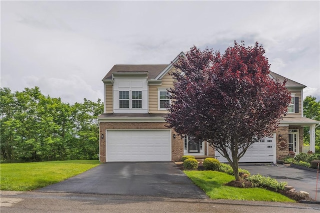 2278 Flint Dr, South Strabane, PA 15301 - view of front of home with asphalt driveway, an attached garage, brick siding, and a front yard