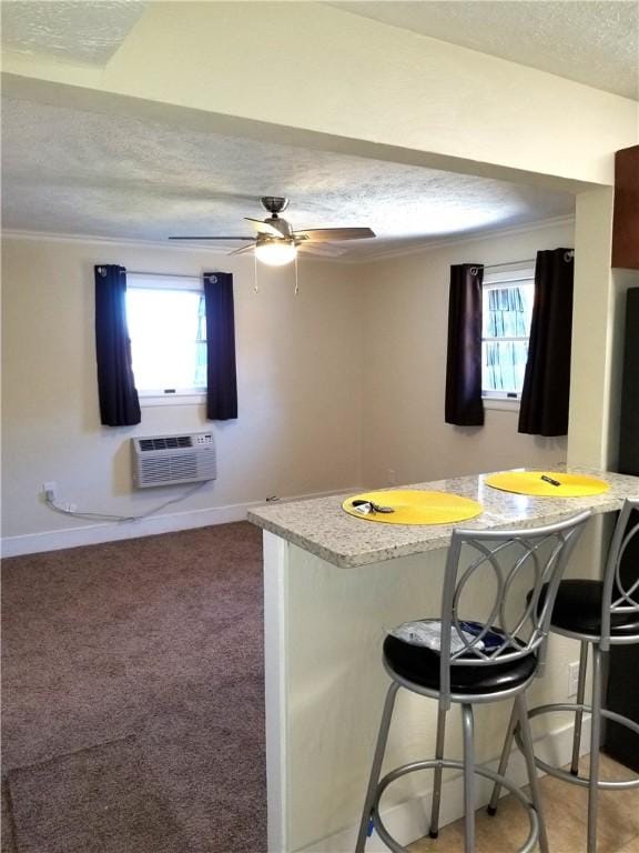 2807 Middle Rd, Hampton, PA 15116 - kitchen featuring a textured ceiling, healthy amount of natural light, a kitchen bar, ceiling fan, and a peninsula