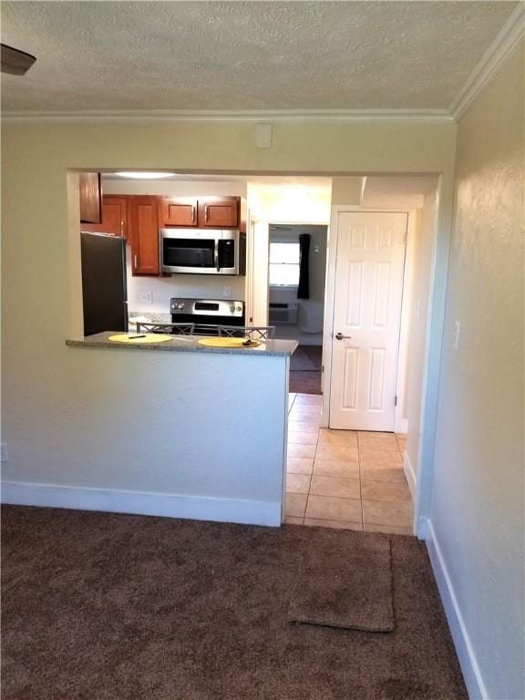 2807 Middle Rd, Hampton, PA 15116 - kitchen with appliances with stainless steel finishes, crown molding, brown cabinets, a textured ceiling, and light colored carpet