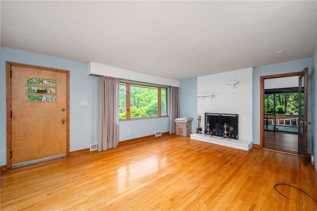 1833 Allison Ave, Mccandless, PA 15101 - unfurnished living room featuring light wood-style flooring and a brick fireplace