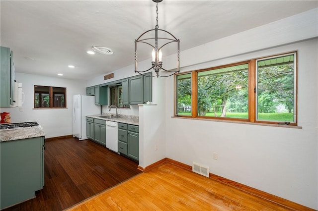 1833 Allison Ave, Mccandless, PA 15101 - kitchen with white appliances, green cabinets, a chandelier, light countertops, and dark wood finished floors