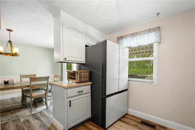 3118 Ridge Rd, South Park, PA 15129 - kitchen featuring freestanding refrigerator, a chandelier, light wood finished floors, white cabinets, and light countertops