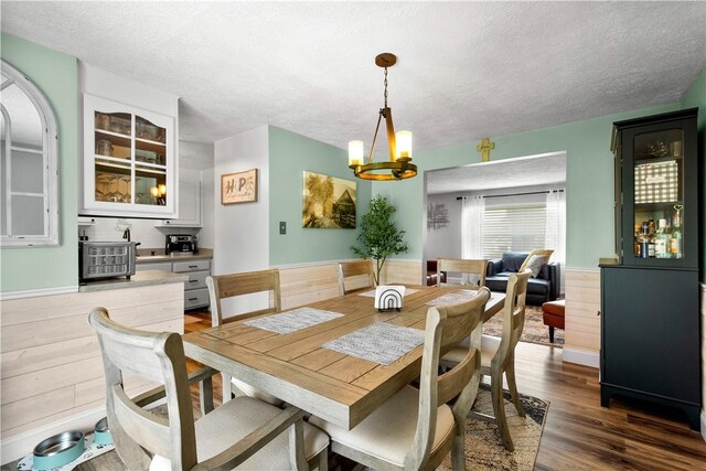 3118 Ridge Rd, South Park, PA 15129 - dining area featuring a textured ceiling, a chandelier, wood finished floors, and wood walls