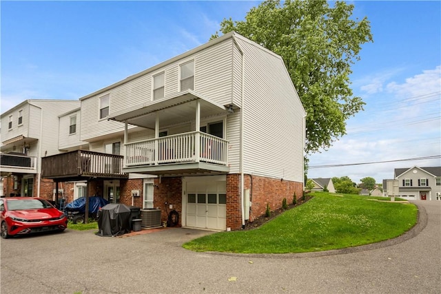 3118 Ridge Rd, South Park, PA 15129 - view of property featuring brick siding, a front lawn, a garage, asphalt driveway, and a balcony
