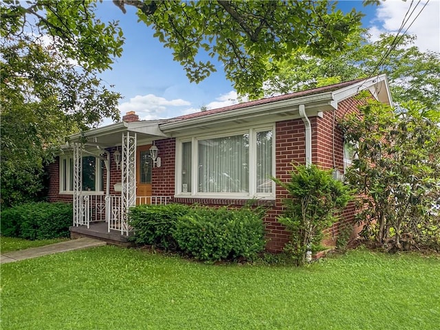 7 E Sheridan Ave, New Castle/1St, PA 16105 - view of front of home with brick siding, a front lawn, and a chimney