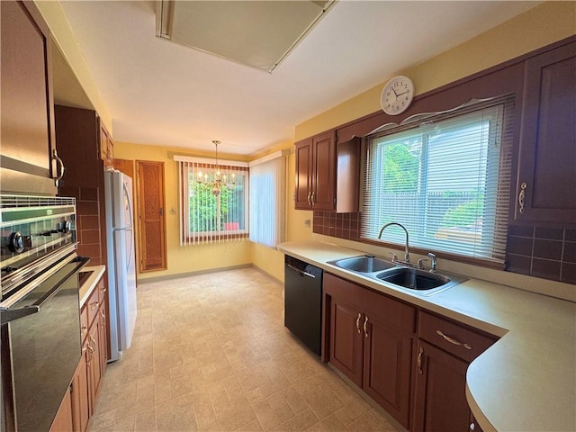 7 E Sheridan Ave, New Castle/1St, PA 16105 - kitchen featuring oven, dishwasher, healthy amount of natural light, and backsplash