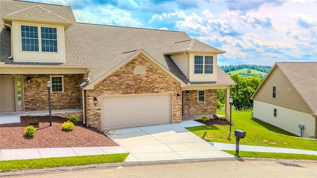 740 Sandstone Way, Rostraver, PA 15012 - view of front of house with concrete driveway, a garage, roof with shingles, a front yard, and stone siding