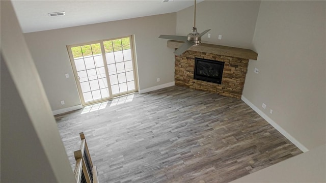 740 Sandstone Way, Rostraver, PA 15012 - unfurnished living room with a ceiling fan, a fireplace, wood finished floors, and lofted ceiling