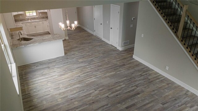 740 Sandstone Way, Rostraver, PA 15012 - corridor with dark wood finished floors, stairs, and a chandelier