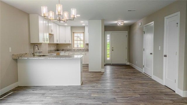740 Sandstone Way, Rostraver, PA 15012 - kitchen with a peninsula, a chandelier, white cabinetry, wood finished floors, and recessed lighting