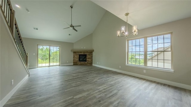 740 Sandstone Way, Rostraver, PA 15012 - unfurnished living room featuring a chandelier, a ceiling fan, wood finished floors, high vaulted ceiling, and a fireplace