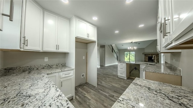740 Sandstone Way, Rostraver, PA 15012 - kitchen featuring light wood-style flooring, white cabinets, light stone countertops, recessed lighting, and a chandelier