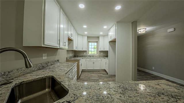 740 Sandstone Way, Rostraver, PA 15012 - kitchen featuring wood finished floors, light stone countertops, recessed lighting, and white cabinetry