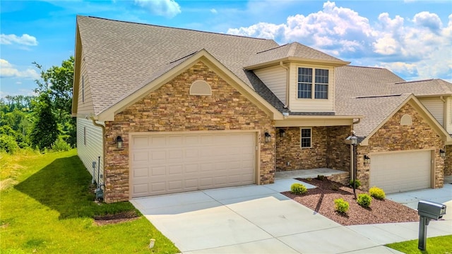 742 Sandstone Way, Rostraver, PA 15012 - view of front facade with a front yard, stone siding, concrete driveway, roof with shingles, and an attached garage