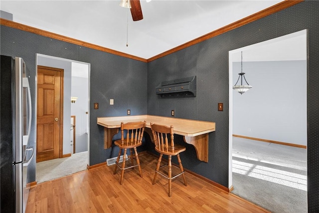 228 Bowman Rd, South Fayette, PA 15017 - dining room featuring light wood-type flooring, ceiling fan, and ornamental molding