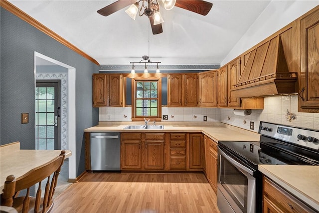 228 Bowman Rd, South Fayette, PA 15017 - kitchen with stainless steel appliances, premium range hood, light wood-style floors, brown cabinets, and lofted ceiling