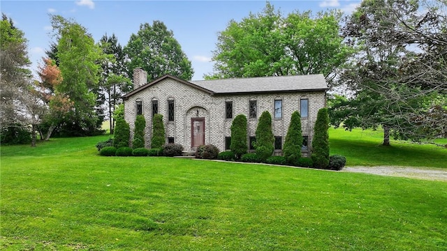 228 Bowman Rd, South Fayette, PA 15017 - raised ranch featuring a chimney, a front yard, and brick siding