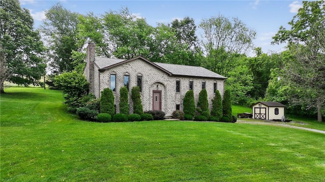 228 Bowman Rd, South Fayette, PA 15017 - view of front facade with a chimney, a shed, a front lawn, and brick siding