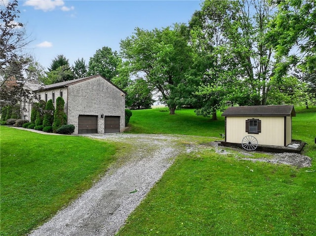 228 Bowman Rd, South Fayette, PA 15017 - view of grassy yard with driveway and an outdoor structure