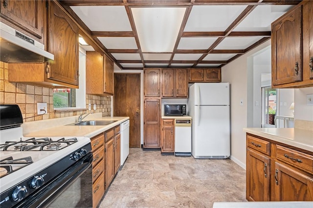 4457 Woodhill Dr, Munhall, PA 15120 - kitchen featuring white appliances, under cabinet range hood, decorative backsplash, and plenty of natural light