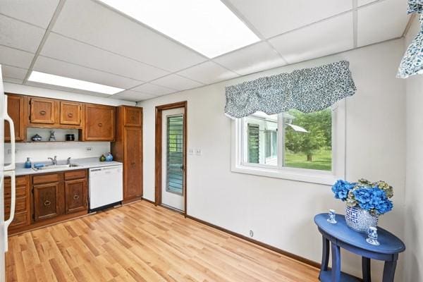 1112 Grigsby, Shenango Twp Law, PA 16101 - kitchen featuring white dishwasher, a drop ceiling, brown cabinetry, light countertops, and light wood finished floors