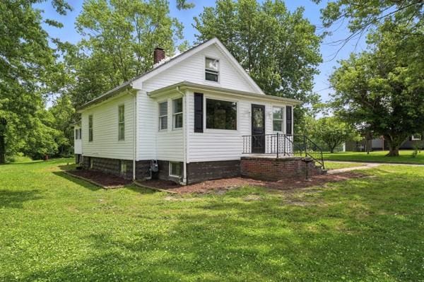 1112 Grigsby, Shenango Twp Law, PA 16101 - view of side of property with a chimney and a yard