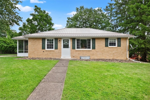 200 Anderson Pl, Shaler, PA 15116 - view of front of house featuring a front yard, a sunroom, brick siding, and a metal roof