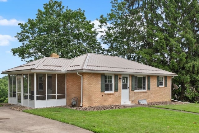 200 Anderson Pl, Shaler, PA 15116 - ranch-style house featuring a sunroom, a front lawn, brick siding, a chimney, and a metal roof