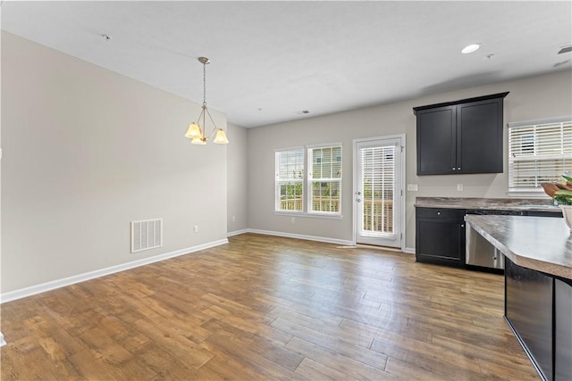 2804 Pointe View Dr, Adams Twp, PA 16046 - kitchen with wood finished floors, dark cabinets, hanging light fixtures, a chandelier, and open floor plan