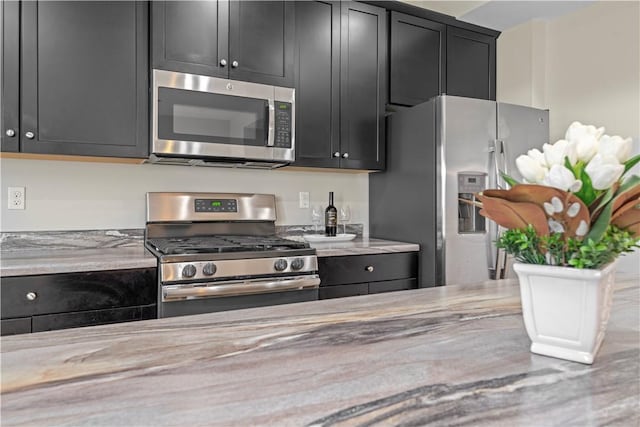 2804 Pointe View Dr, Adams Twp, PA 16046 - kitchen with appliances with stainless steel finishes, dark cabinets, and light stone counters