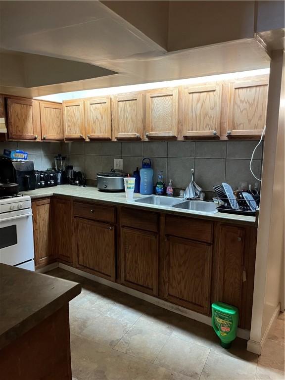 38 Rostock St, Spring Hill, PA 15212 - kitchen featuring white range with gas stovetop and decorative backsplash