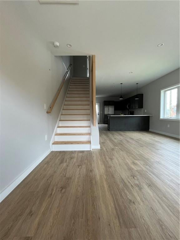 843 Ledlie St, Hill District, PA 15219 - unfurnished living room featuring light wood-style floors and stairway