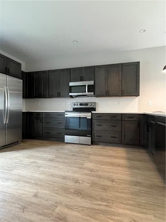 843 Ledlie St, Hill District, PA 15219 - kitchen featuring appliances with stainless steel finishes, light wood finished floors, light countertops, tasteful backsplash, and recessed lighting