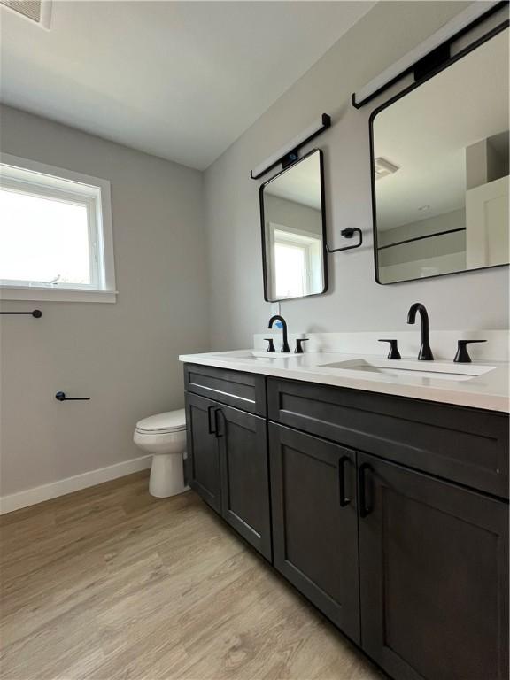 843 Ledlie St, Hill District, PA 15219 - bathroom featuring double vanity and wood finished floors
