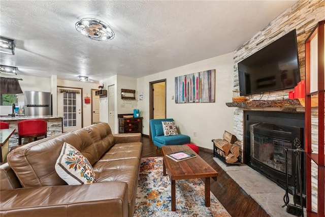 1147 Tanyard Ln, Hidden Valley, PA 15502 - living area with a fireplace, wood finished floors, and a textured ceiling