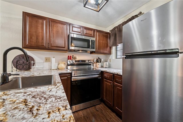 1147 Tanyard Ln, Hidden Valley, PA 15502 - kitchen with stainless steel appliances, dark wood finished floors, and light stone counters