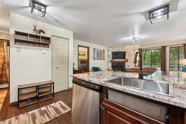 1147 Tanyard Ln, Hidden Valley, PA 15502 - kitchen with dishwasher, a stone fireplace, dark wood-style floors, light stone countertops, and a textured ceiling