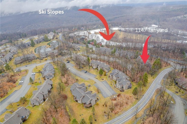 1147 Tanyard Ln, Hidden Valley, PA 15502 - aerial view of property and surrounding area with nearby suburban area and a heavily wooded area