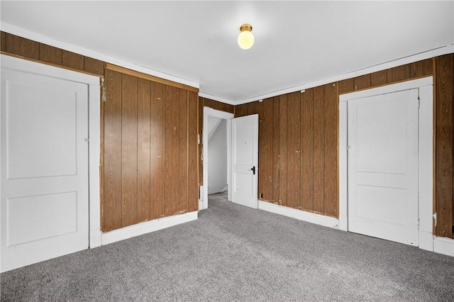 1201 3rd Ave, Beaver Falls, PA 15010 - unfurnished bedroom featuring carpet flooring, wood walls, and a closet