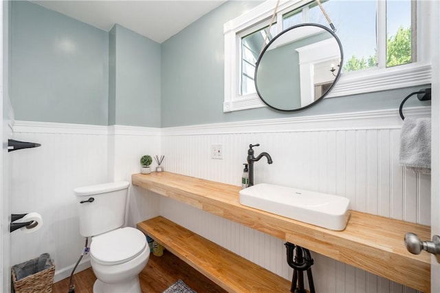 1155 French St, Sharon, PA 16146 - half bath featuring healthy amount of natural light, wainscoting, and wood finished floors