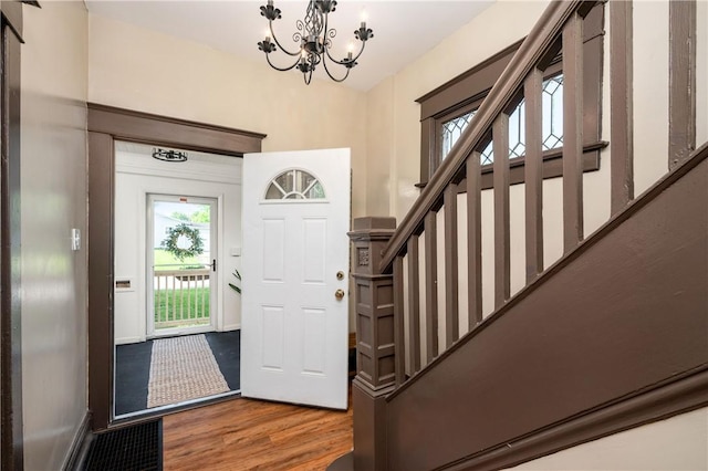 1155 French St, Sharon, PA 16146 - entryway featuring wood finished floors, stairs, and a chandelier