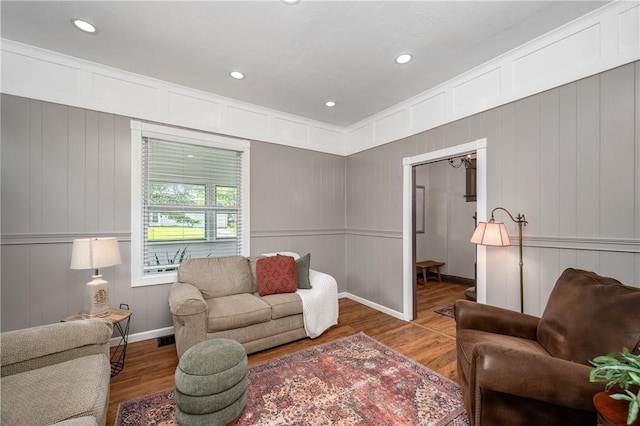 1155 French St, Sharon, PA 16146 - living room featuring wood finished floors, a decorative wall, and recessed lighting