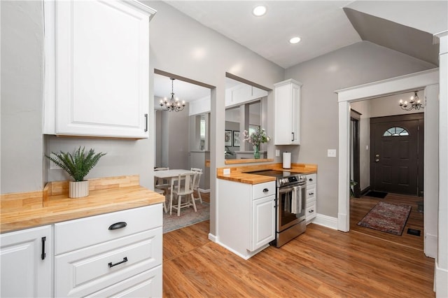 1155 French St, Sharon, PA 16146 - kitchen with butcher block counters, stainless steel electric stove, a chandelier, light wood-type flooring, and recessed lighting