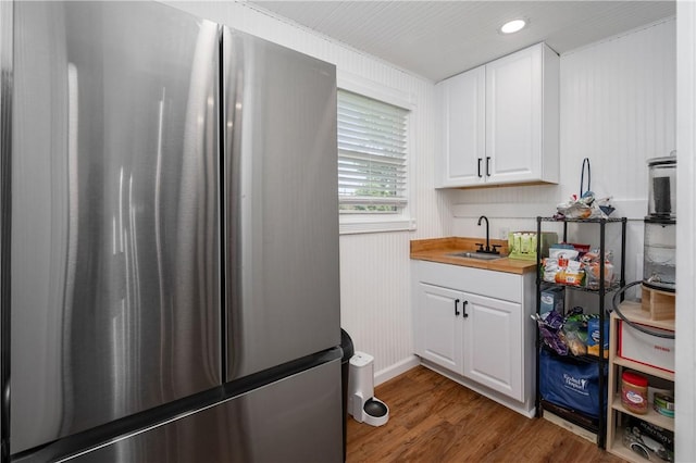 1155 French St, Sharon, PA 16146 - kitchen with freestanding refrigerator, white cabinets, wood finished floors, recessed lighting, and butcher block counters