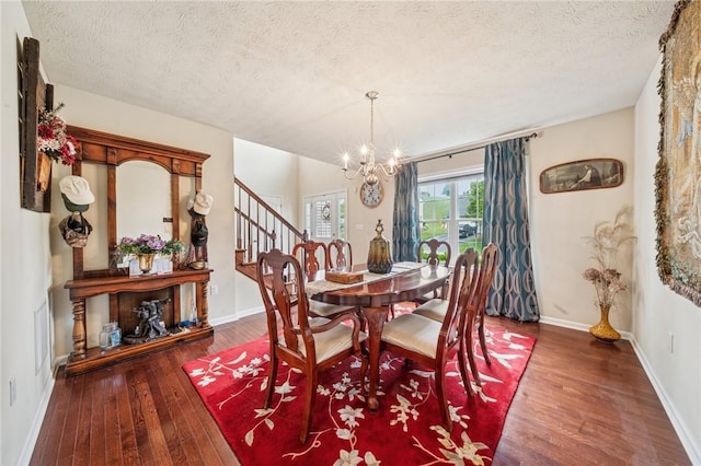517 Callie Ct, Rostraver, PA 15089 - dining room with hardwood / wood-style floors, a chandelier, a textured ceiling, and stairs